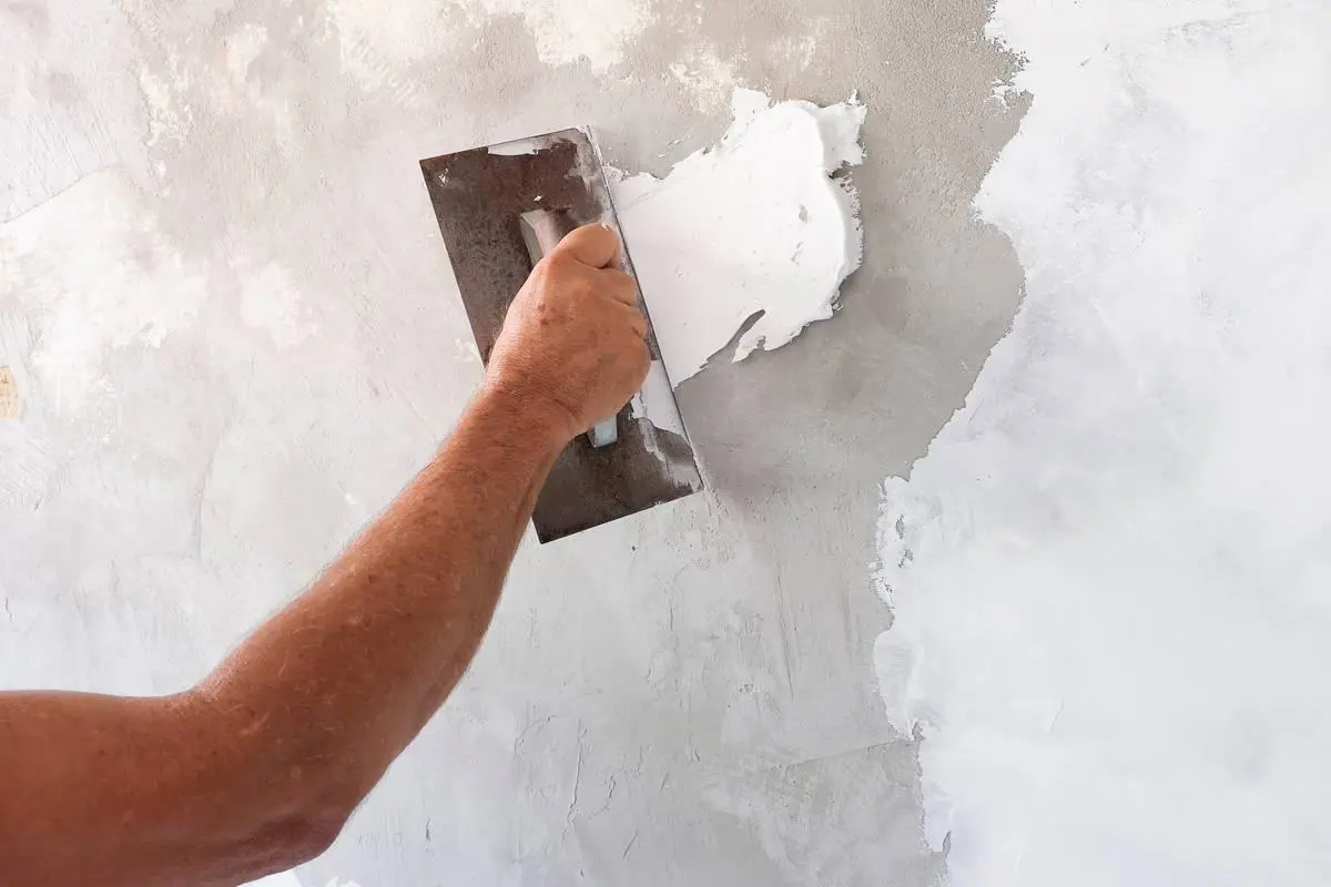 Artisan Econstrutec posant du carrelage lors d'une rénovation de salle de bain